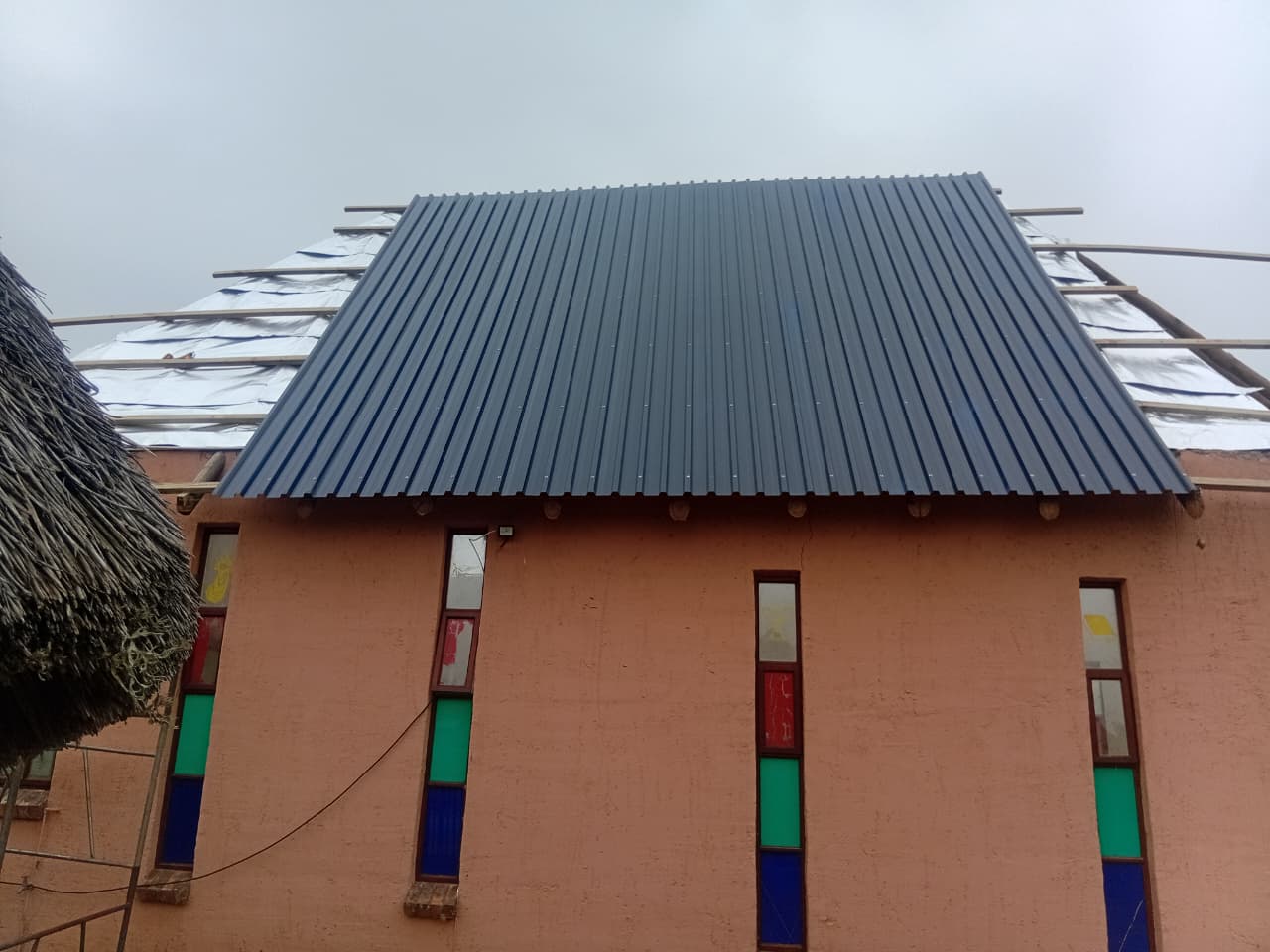 New charcoal roof sheeting being installed